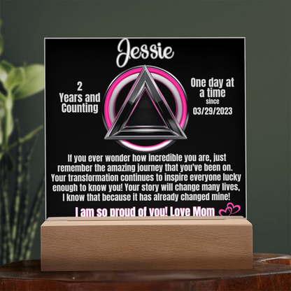 Personalized LED sobriety milestone plaque with pink glow triangle motif on wooden base