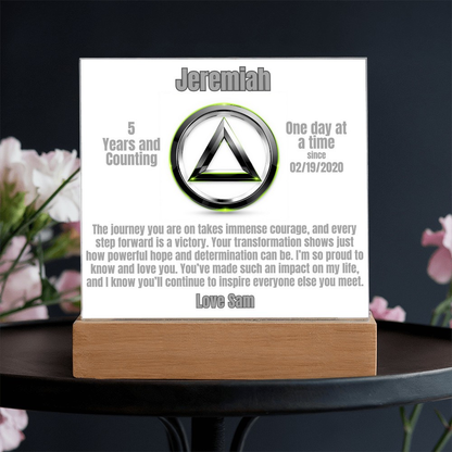 Personalized LED plaque with circular emblem and wooden base on tabletop