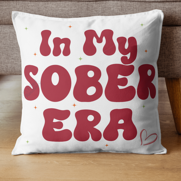 White throw pillow with red typographic “In My Sober Era” design and small sparkles