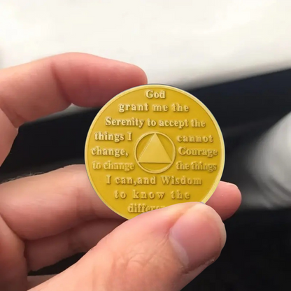 Gold prayer text coin with triangle symbol in center; circular coin with dark letters
