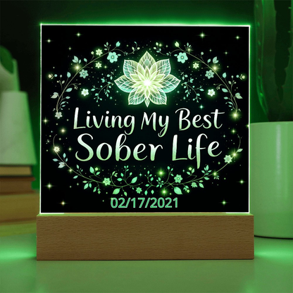 LED acrylic plaque with “Living My Best Sober Life” glowing floral lights on wooden base