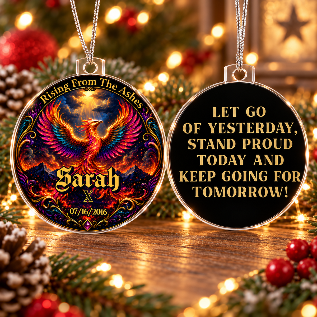 Two round acrylic ornaments with phoenix design and “Let go of yesterday” message