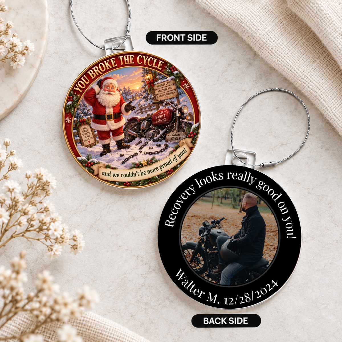 Two round acrylic hanging ornaments on light stone with Santa front and recovery photo back