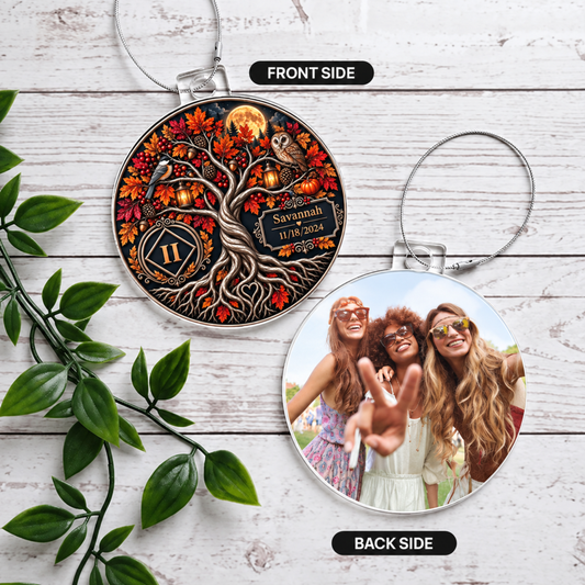 Two round acrylic ornaments hanging, front owl tree design and back women photo