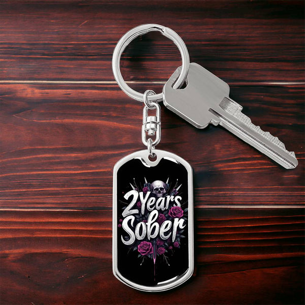 Silver dog tag keychain with skull and roses design reading '2 Years Sober'.