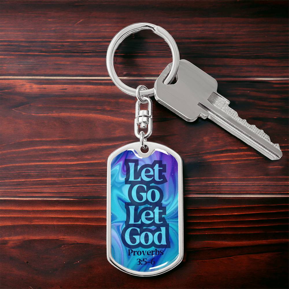 Silver dog tag keychain with blue front reading “Let Go Let God” and keys attached