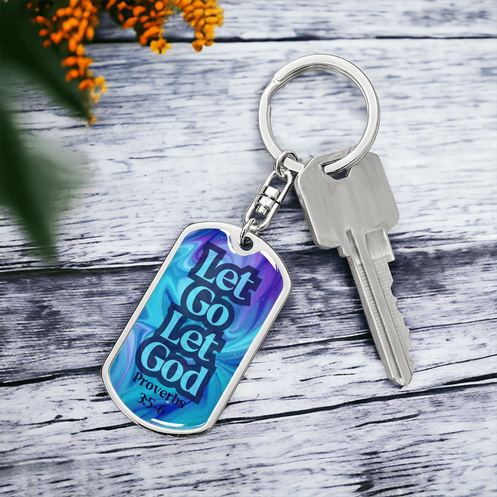 Silver dog tag keychain with blue front reading “Let Go Let God” and Proverbs 3:5-6