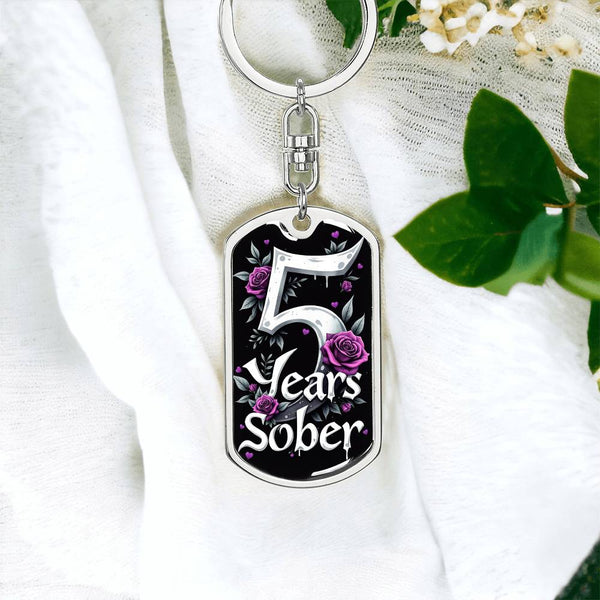 Silver dog tag keychain with 5 Years Sober design and purple rose accents