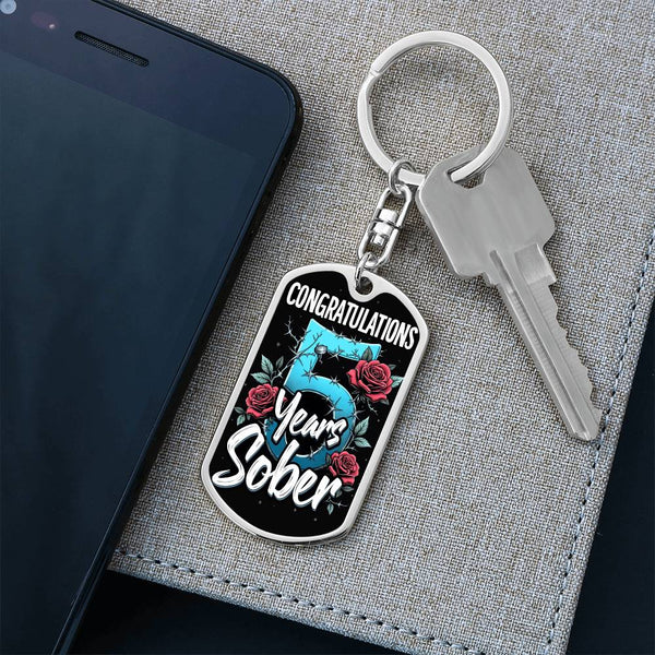 Silver keychain with oval pendant and key, “CONGRATULATIONS” and “Years Sober” artwork