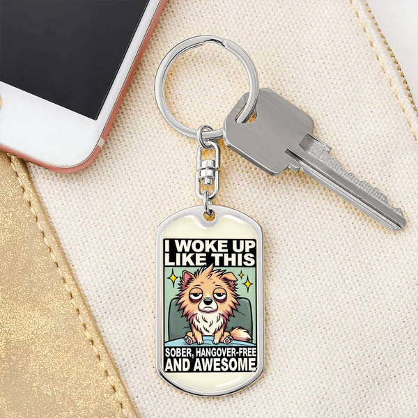 Silver dog tag keychain with illustrated bear-like dog and the text "I Woke Up Like This"
