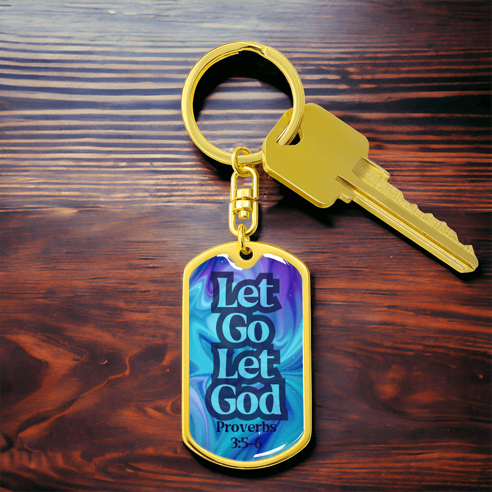 Gold dog tag keychain with blue front reading “Let Go Let God” and keys attached