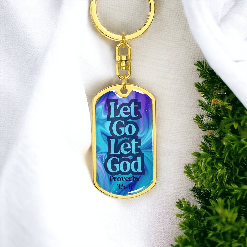 Gold dog tag keychain with blue front reading “Let Go Let God” and Proverbs 3:5-6