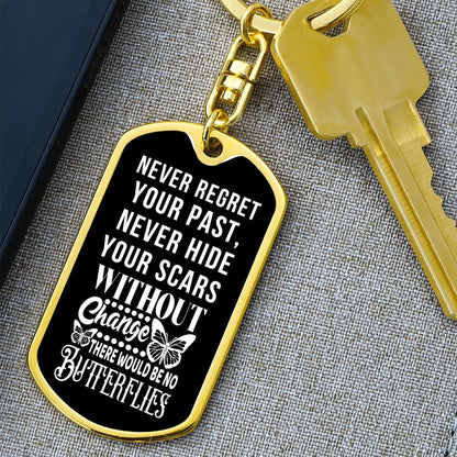 Gold dog tag swivel keychain with motivational quote on a black enamel face