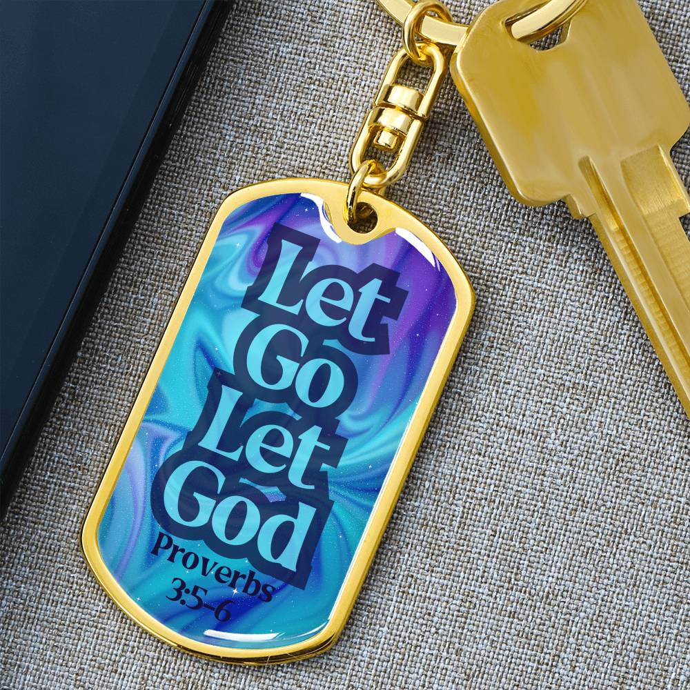 Gold dog tag keychain with blue front reading “Let Go Let God” and Proverbs 3:5-6