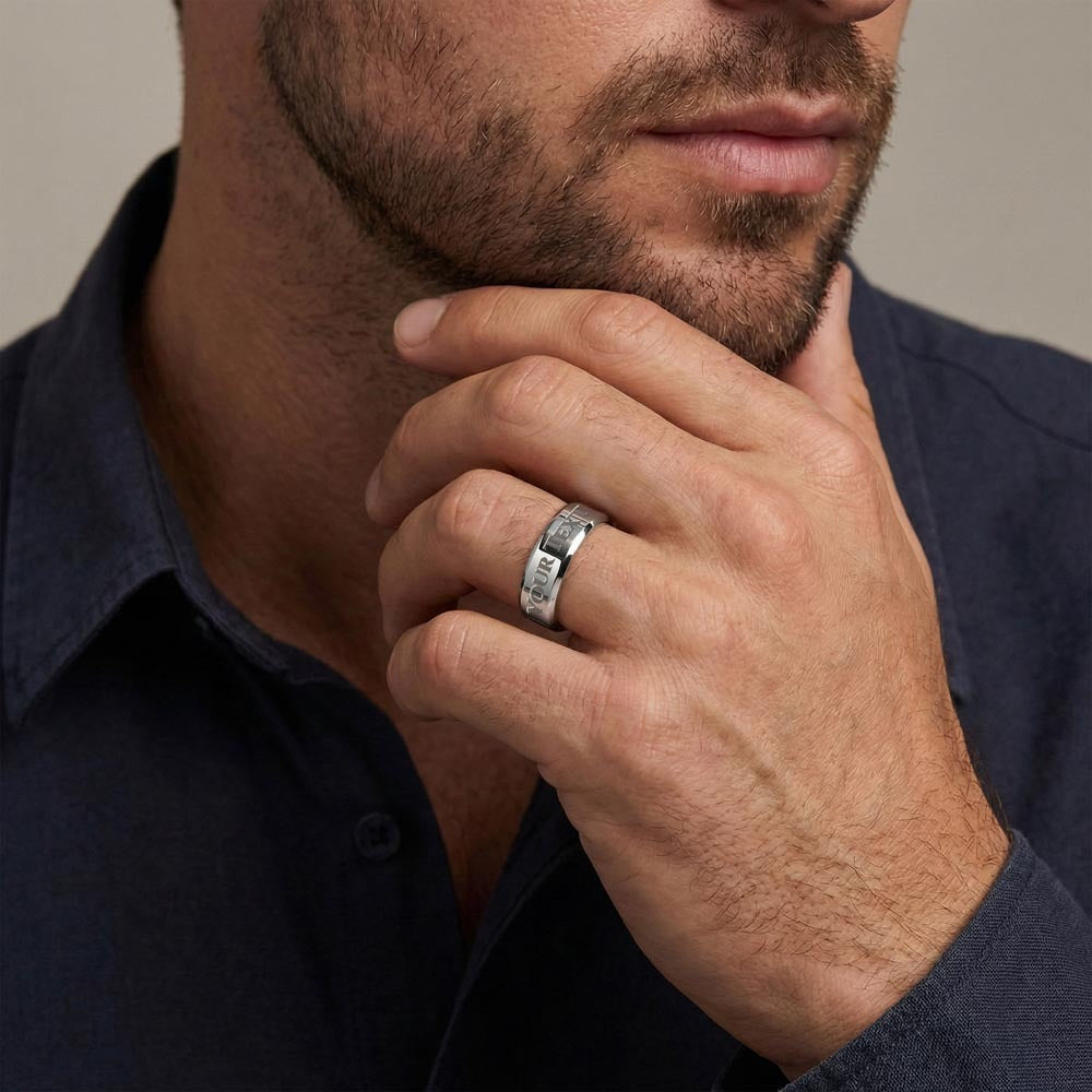 Man wearing a silver-tone engraved band ring