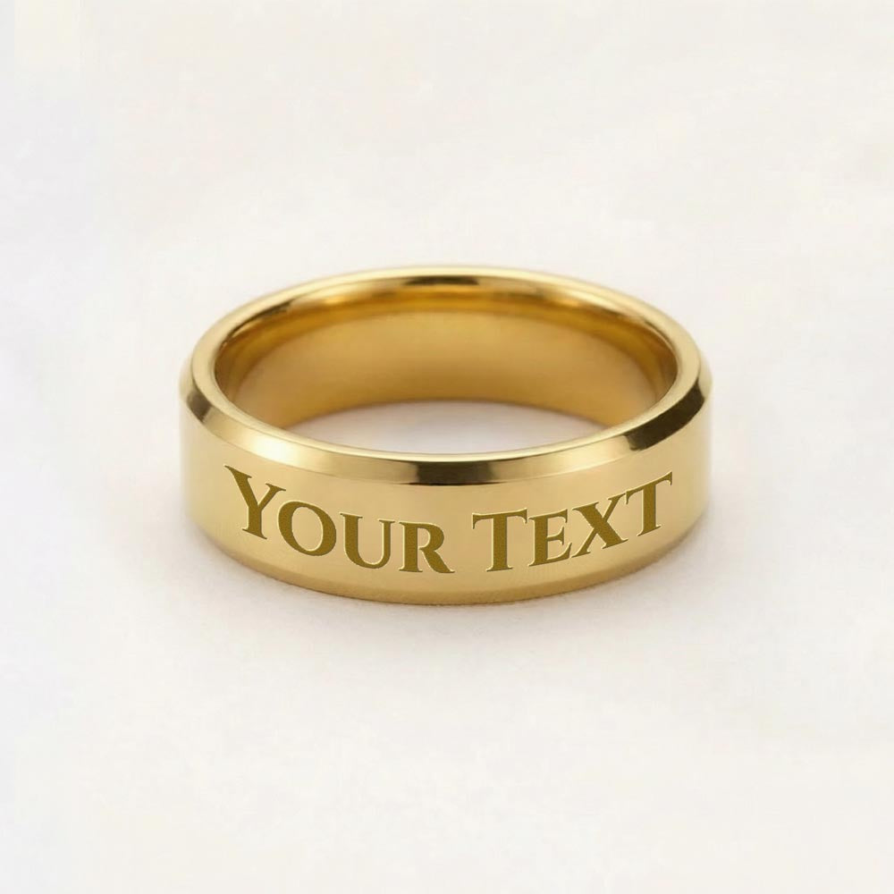 Engraved gold-tone band ring with “YOUR TEXT” lettering