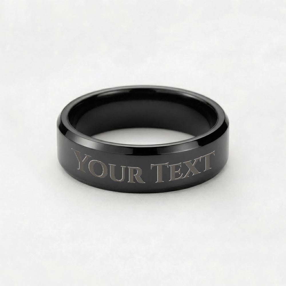 Engraved dark-tone band ring with “YOUR TEXT” lettering