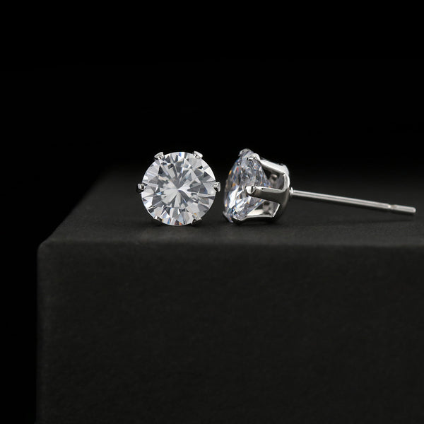 Clear cubic zirconia stud earrings with round and square-cut stones, silver-tone settings