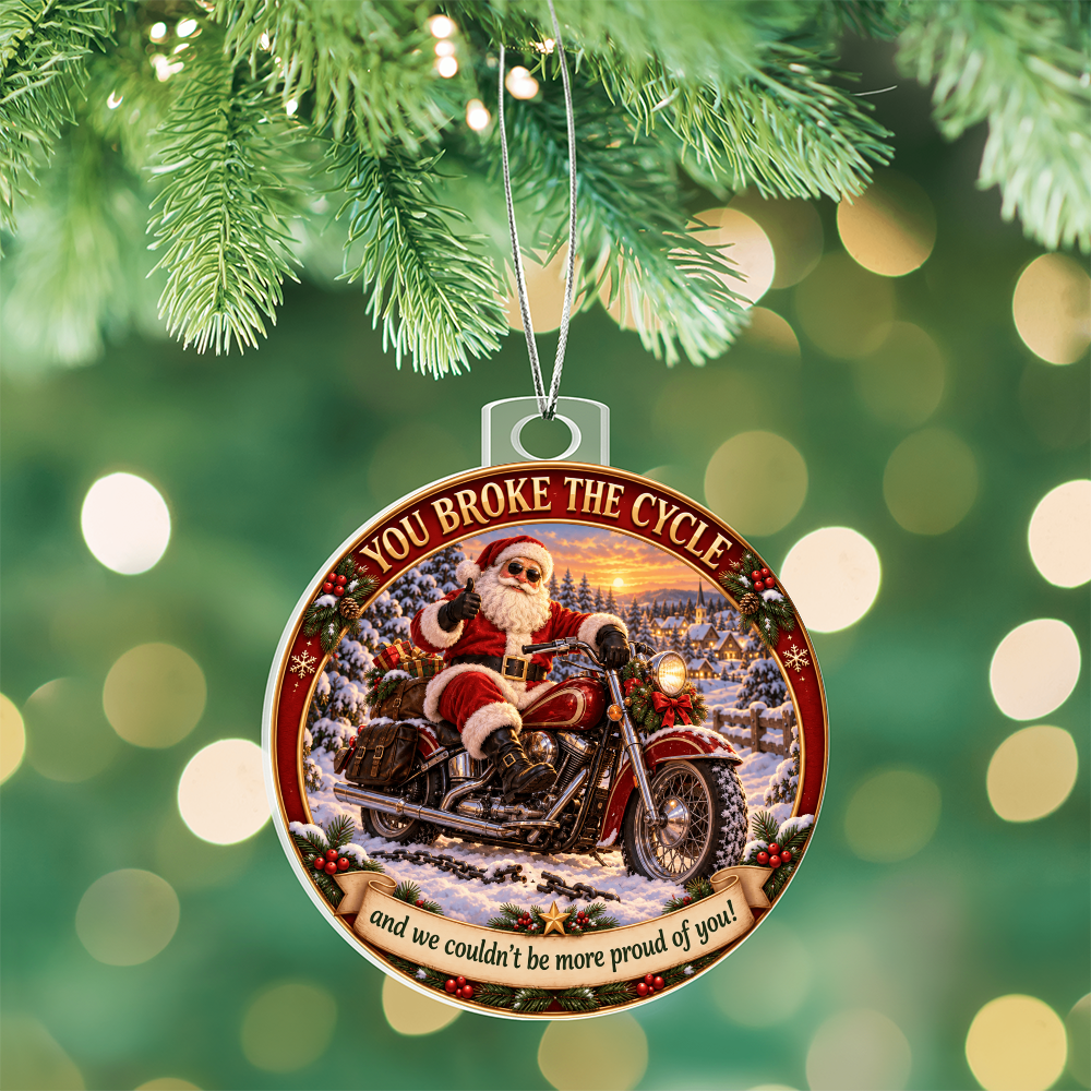 Round acrylic Santa motorcycle ornament hanging from a Christmas tree with silver chain