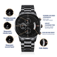Men's black chronograph wrist watch with labeled functions on a front view