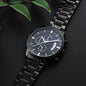 Black chronograph wristwatch with metal link bracelet, dark dial and subdials