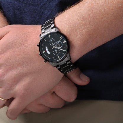 Black men’s wristwatch with metal link bracelet worn on a man’s wrist