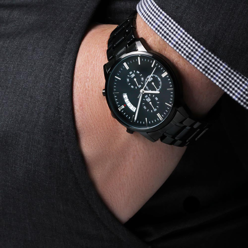 Black chronograph watch on wrist with metal bracelet and round dial