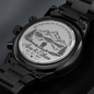 Engraved round caseback on black metal wristwatch, close-up view