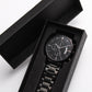 Black wristwatch in open black gift box with foam insert and metal link band