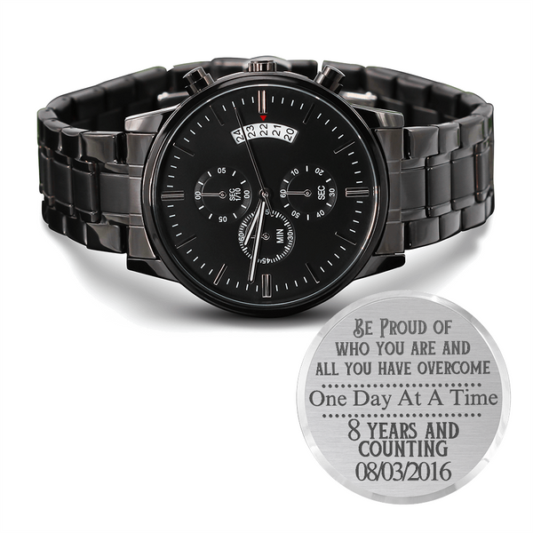 Black metal chronograph watch with three subdials and date window on bracelet