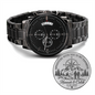 Black chronograph wrist watch with metal bracelet and engraved adventure medallion