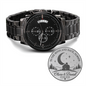 Black chronograph wristwatch with metal link bracelet, three subdials and date window.