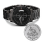 Black stainless steel wristwatch with round chronograph dial and engraved medallion tag