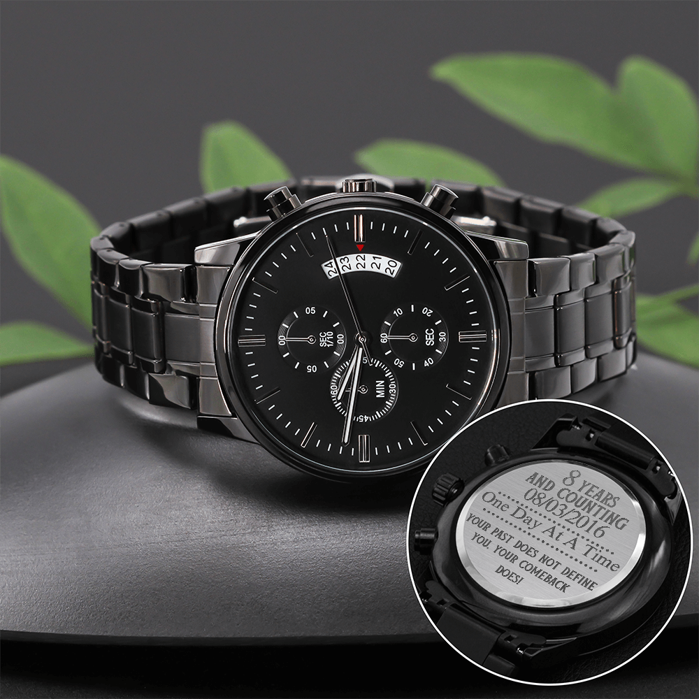 Black men’s chronograph wristwatch with metal link bracelet and engraved back disc