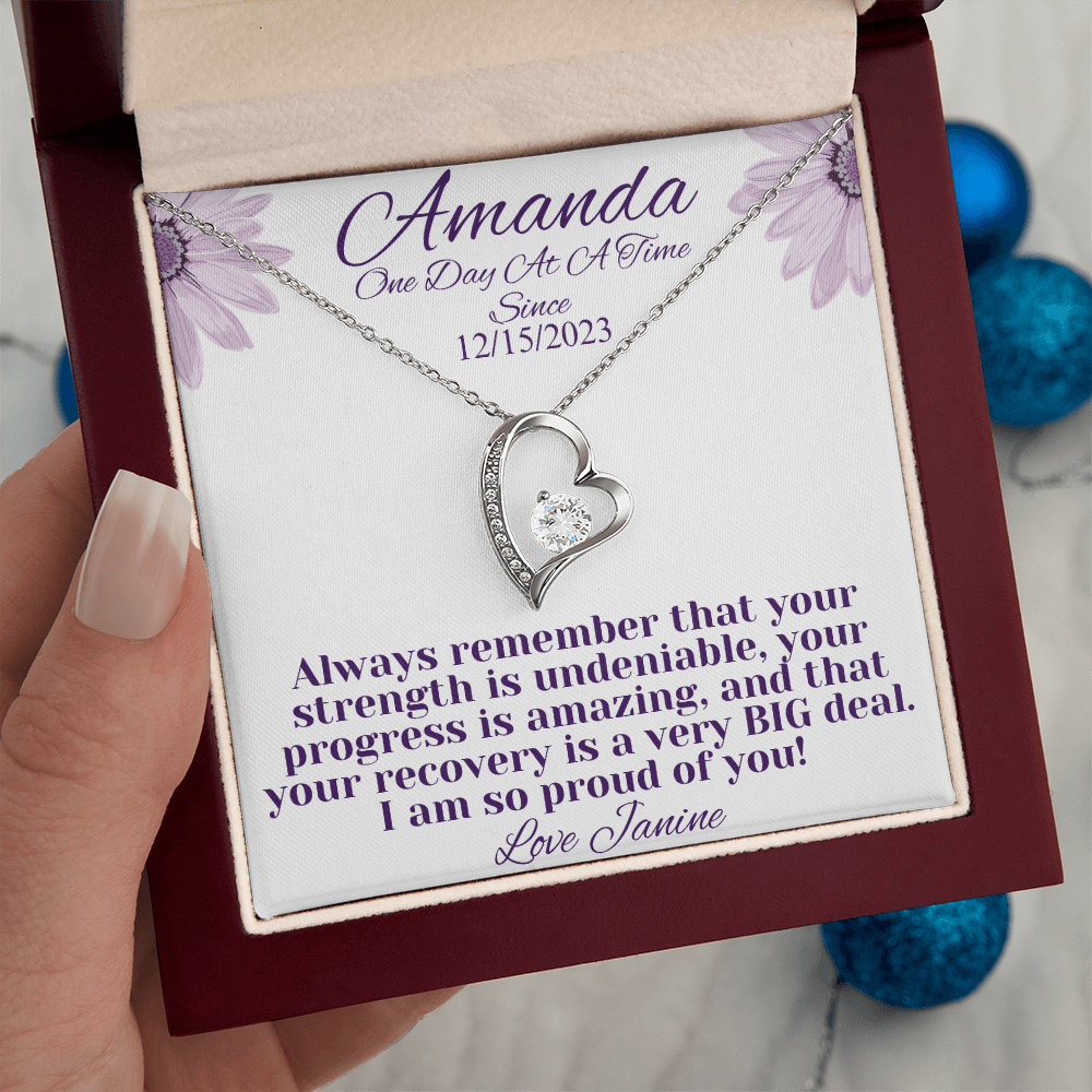 Silver heart recovery necklace with crystal-studded pendant in red gift box