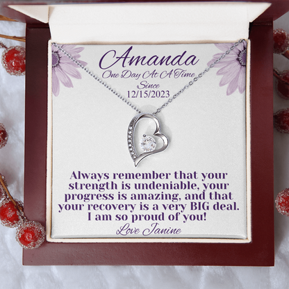 Silver heart recovery necklace with crystal-studded pendant in red gift box