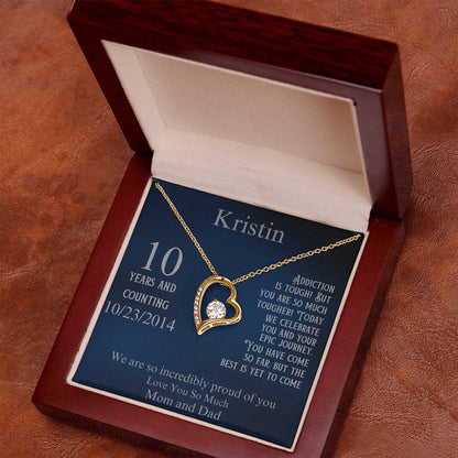 Gold heart pendant necklace in open gift box, with blue card and date 10/23/2014