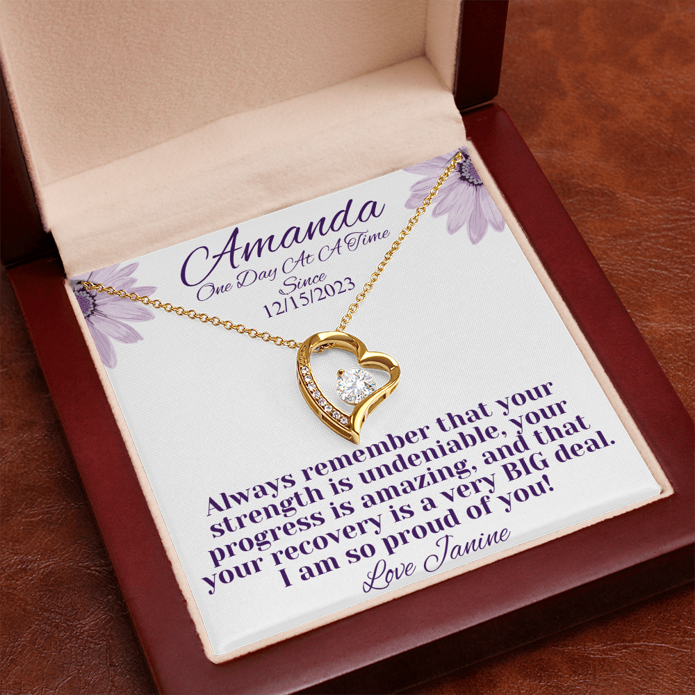 Gold heart recovery necklace with crystal-studded pendant in red gift box