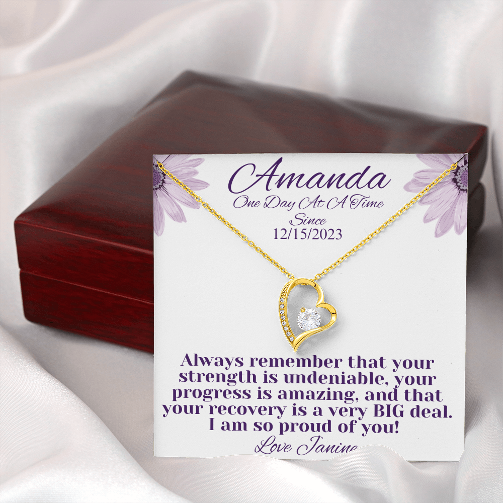 Gold heart recovery necklace with diamond-like center stone and side crystals, chain