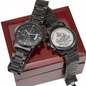 Two black chronograph wristwatches shown on a red wooden gift box lid