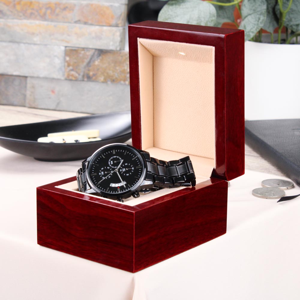 Men's black chronograph wrist watch in an open red wooden gift box