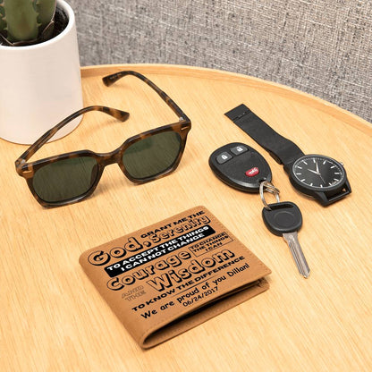 Tan leather wallet with printed sobriety message, lying on a tabletop with key fob