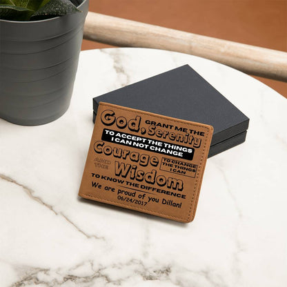 Tan leather wallet with printed sobriety message and date, placed on a dark box