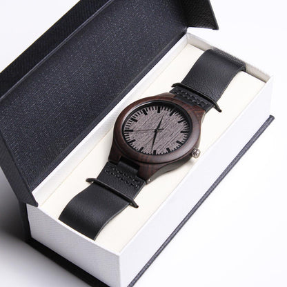 Wood watch with black leather strap, grey textured dial with three hands