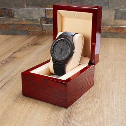 Engraved wood wrist watch in open red-brown wooden gift box, black dial and strap