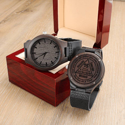 Two wood watches with black leather straps, engraved back and grey front dials