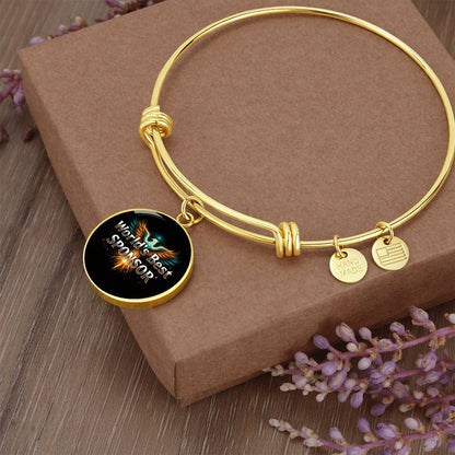 Gold bangle bracelet with round “World’s Best Sponsor” charm and small side tags