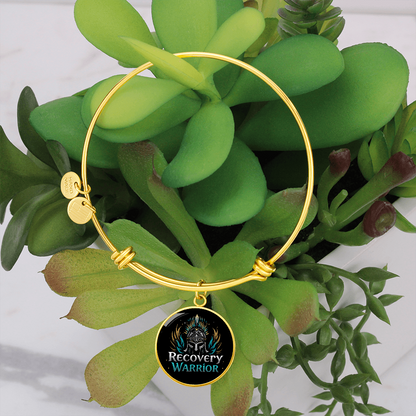 Gold bangle bracelet with round warrior emblem medallion and hinge clasp