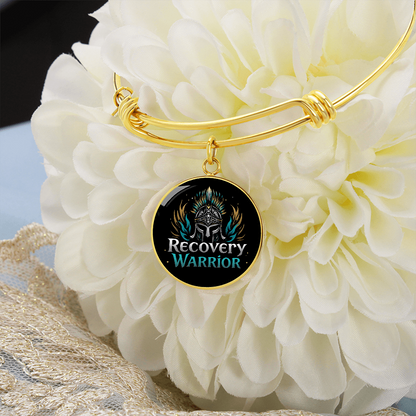 Gold bangle bracelet with round warrior emblem charm and twisted knot detail