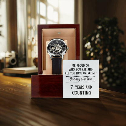 Openwork watch in gift box with dark leather strap and skeleton dial display.